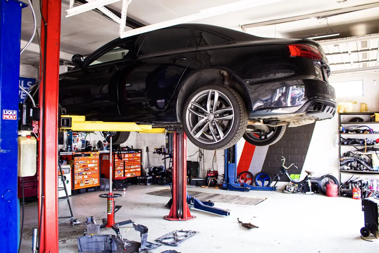 Inside the Quattrowerks shop with a car on lift
